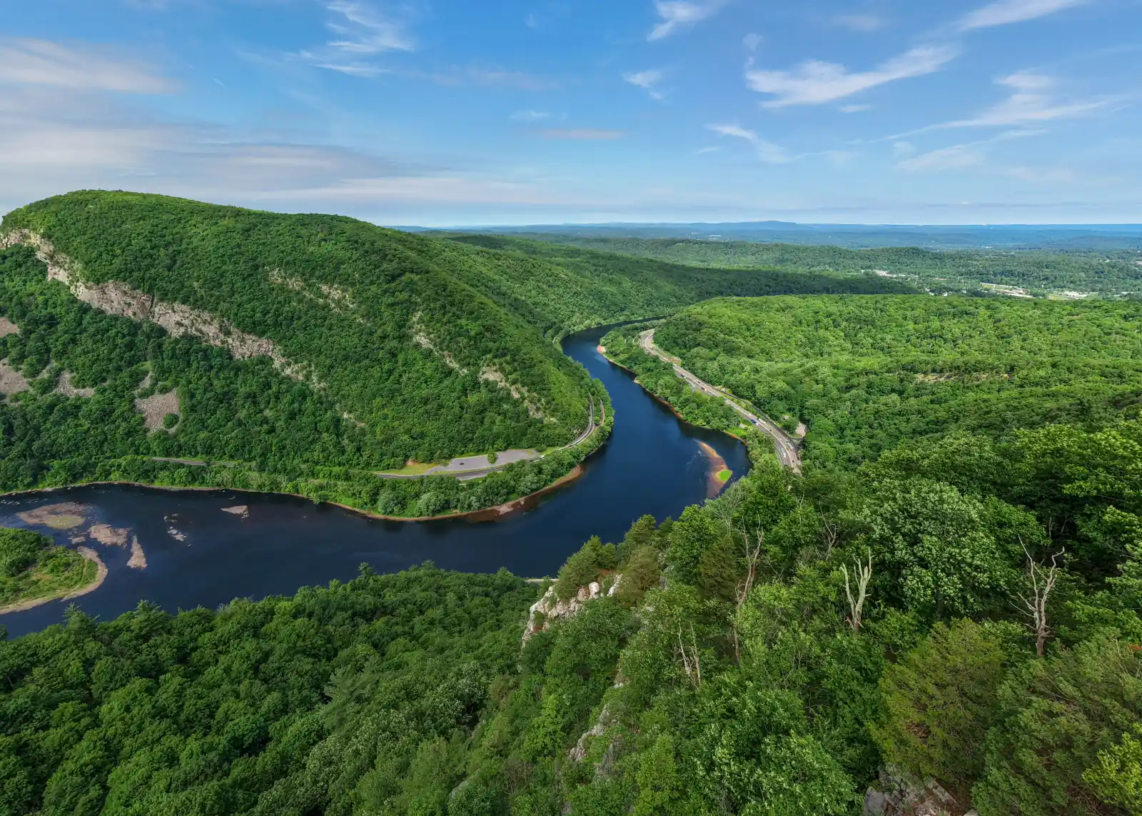 Aerial view of the Delaware River winding through the forested Delaware Water Gap between New Jersey and Pennsylvania.